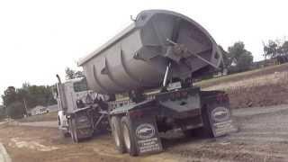 New Western Star Truck Tipping its Sidedump On the Fly with a Deere 750J dozer