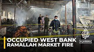 Fire breaks out at Ramallah market amid Israeli raids