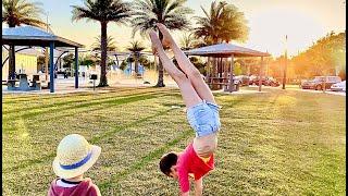 Having fun with gymnastic tricks - Karolina Protsenko with little brother