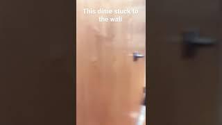 Dime stuck to the wall