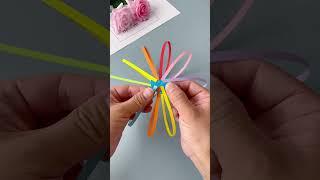 Use colored paper strips to make a small toy for your child. It can be transformed into various sha