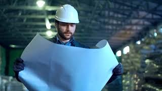 Engineer Holding a Blueprint in a Warehouse | Free Stock Video | Royalty Free Video | No Copyright