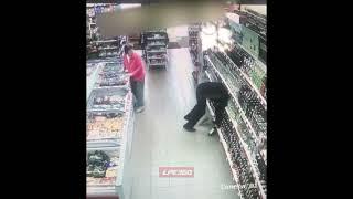 Drunk man falls in liquor shelf in store