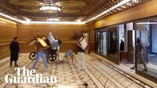 Syrian rebels carry furniture from presidential palace after Assad flees the country