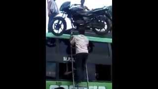 Humans help Motorcycle get a ride on top of a bus - India Edition