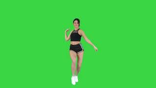 Sexy dancing by young sporty woman on green background