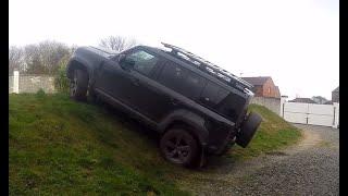 New Land Rover Defender Offroad climbing a steep bank