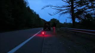 Woman placing EMERGI SAFE Multi-Function Emergency Flare behind her vehicle