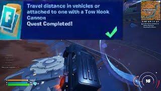 Travel distance in vehicles or attached to one with a Tow Hook Cannon Fortnite