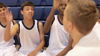 male high school basketball team having team talk with coach