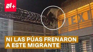 Captan a migrante saltando sobre muro fronterizo y alambre de púas - N+