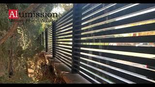 Modern horizontal aluminum fence 1" slats with 1/2" spacers.