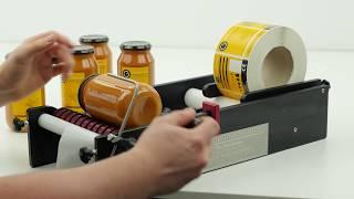 A Jar Being Labelled on the BenchMATE - Manual Labelling Machine