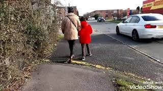 Hidden camera push game mother vs son while walking through pedestrian path in side of the road.