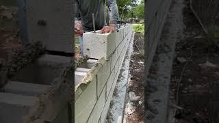 Installing some 8x8x16 CMU blocks for a decretive fence wall