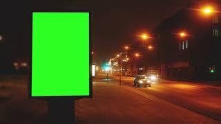 a billboard with a green screen on a streets