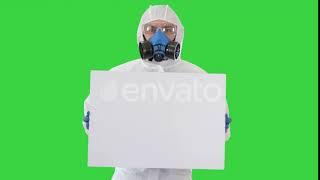 Lab Scientist in Safety Suit Holding Empty White Board on a Green Screen, Chroma Key | Stock Foo...