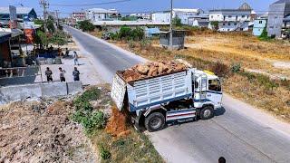 First Start Open New Project Landfill up First dump truck unloading Rock soil Pushing clear by Dozer