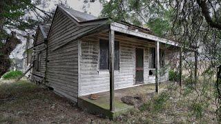 Old hidden rural cottage in the trees and an old rural Hall/School