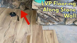 Installing LVP Flooring Along a Rough Stone Wall and Fireplace