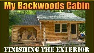 Siding my Backwoods Cabin with logs I milled on my property.