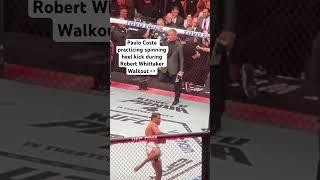 Paulo Costa practicing spinning heel kick during Robert Whittaker walkout at UFC 298