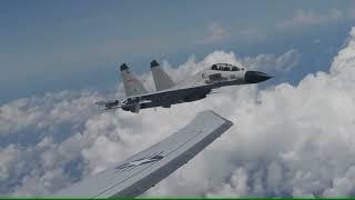 Armed Chinese fighter jet flying dangerously close to American military aircraft