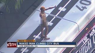 Naked man on top of city bus