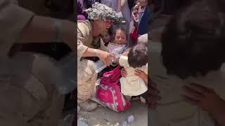 An American soldier gives some water and helping the kids in Afghanistan