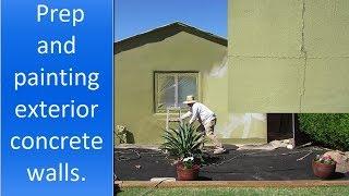 Painting exterior concrete walls of a house.