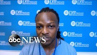 African American doctor wears scrubs as form of protection