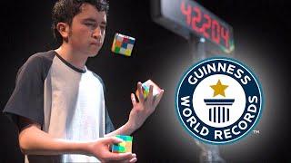 Solving Three Puzzle Cubes WHILST JUGGLING - Guinness World Records