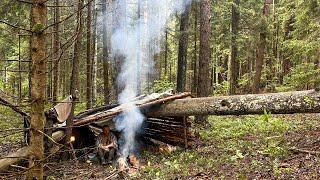 Building a shelter for survival in a wild forest. Escaping from rain and wind far from civilization.