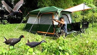 Camping, hunting, surviving under bamboo trees on the river bank