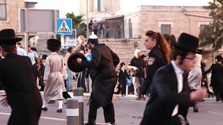 Women in bras confront Ultra-Orthodox Jews protesting against Eurovision