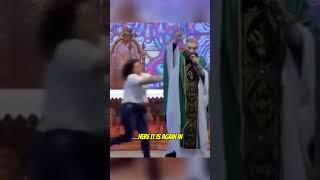 Lady pushes Catholic Priest off a stage while preaching  #shorts