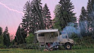 CAMPING WITH A UNIMOG CAMPER AT A RAINY SUNSET