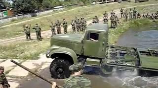 KrAZ 255 Resetting the pontoon bridge. Military equipment.