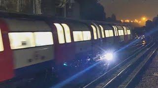 Massive electric sparks from London underground tube trains, while they battle heavy rain at night.