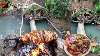 Outdoors Cooking Pork and Buff Meat Rolling Sekwa in open Fire Survival Bushcraft Building in River