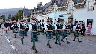 Ballater Pipe Band play Castle Dangerous on the march on eve of 2024 Braemar Gathering in Scotland