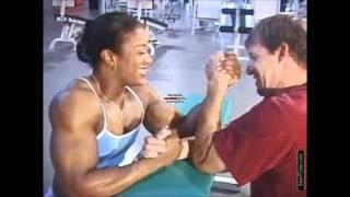 Kim Perez armwrestles against a smaller man