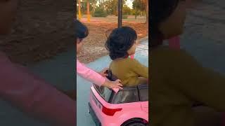 Nooni and Looli driving their toy car 