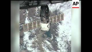 A Russian Soyuz spacecraft docked  with the International Space Station. Two Russians and and Americ