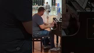 Guy plays piano at Bergamo Airport