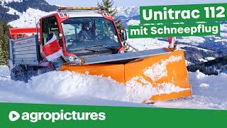 Schnee räumen mit Seitenschneepflug am Lindner Unitrac 112 LDrive | Traktortechnik im Winterdienst