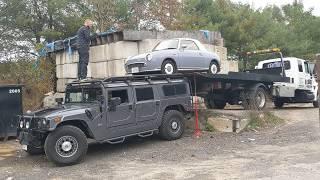 Loading a Figaro onto the roof of a Hummer H1