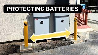 Installing bollards to protect batteries from impact