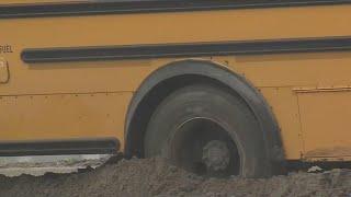 Bus gets stuck in the mud near I-29 ramp