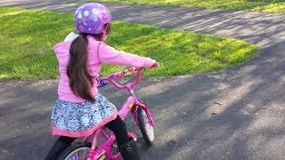 Katie Lendel on a Barbie bike doing stunts